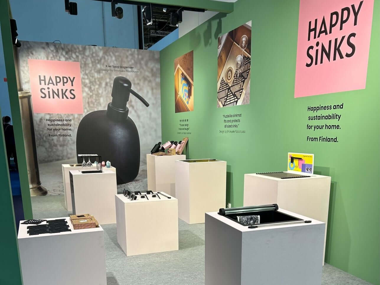 Happy Sinks booth showcasing modern kitchen products including soap dispensers and cutlery caddy at Ambiente 2024 trade fair