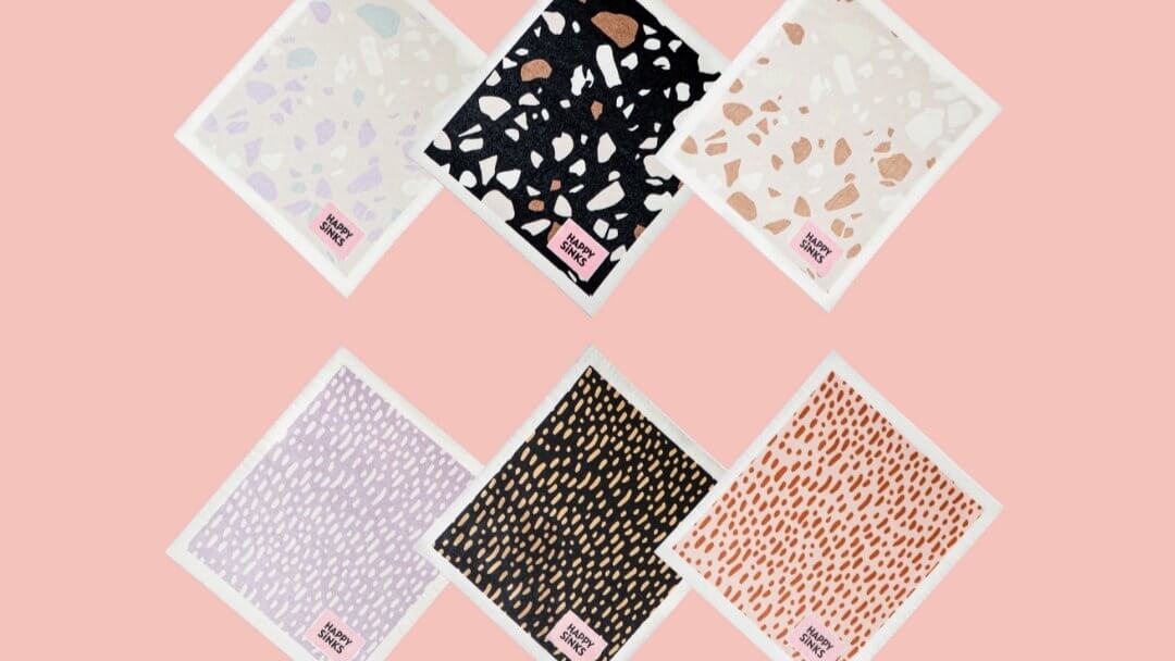 Set of six patterned Swedish dishcloths on a pink background for eco-friendly cleaning