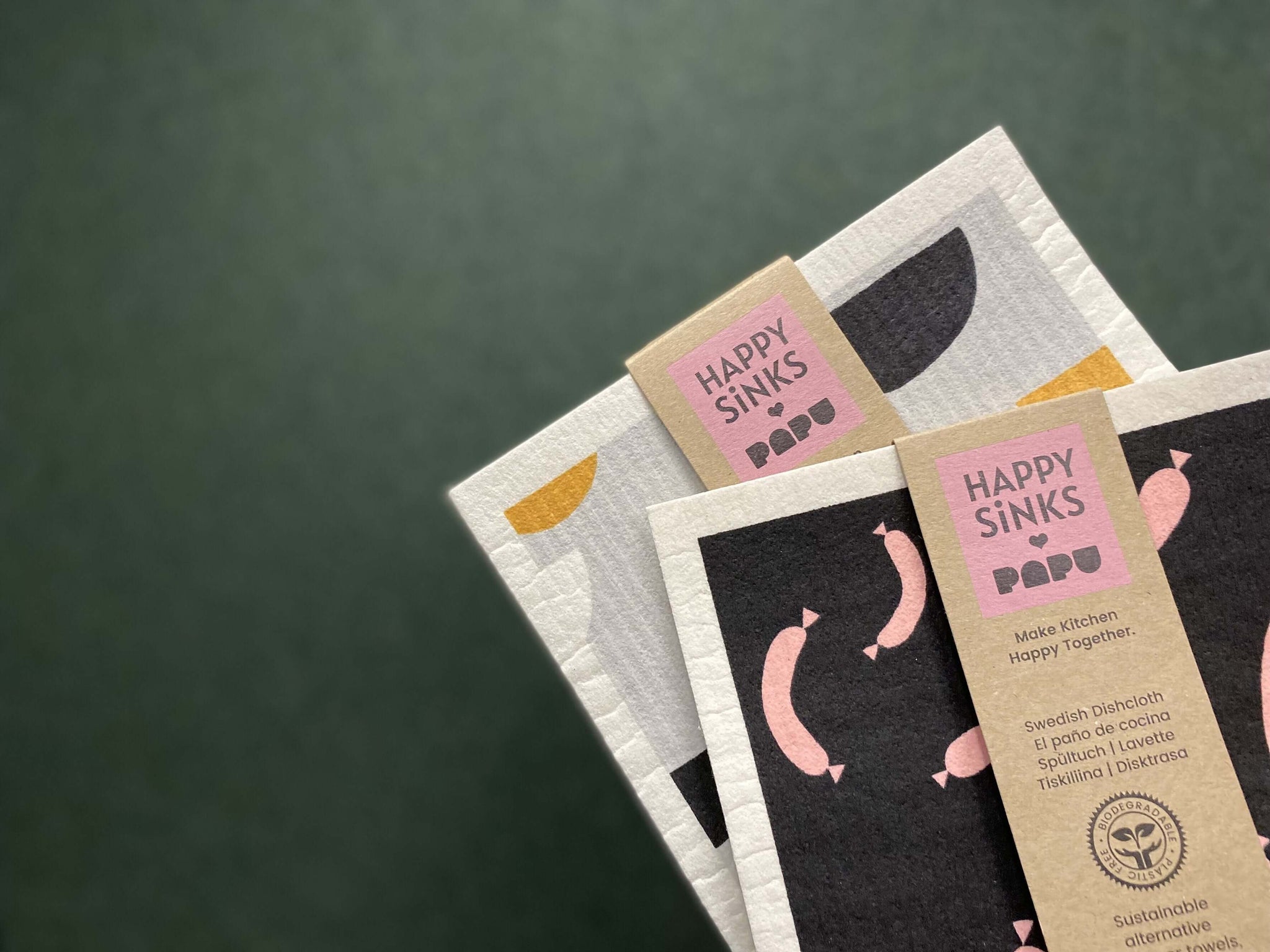 HAPPY SiNKS biodegradable dishcloths with Papu Design patterns featuring pink sausage and bean motifs